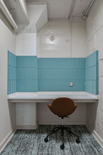 Small workspace nook with teal tile backsplash and white desk